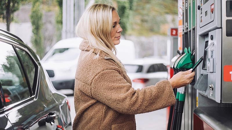 woman paying for fuel