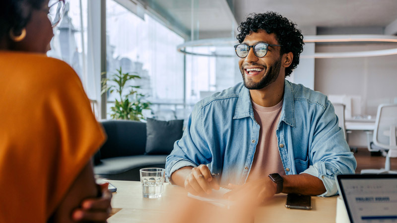 Man laughing in conversation